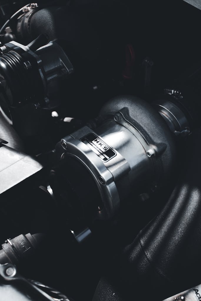 Detailed photo of a turbocharger in an engine, showcasing industrial technology.